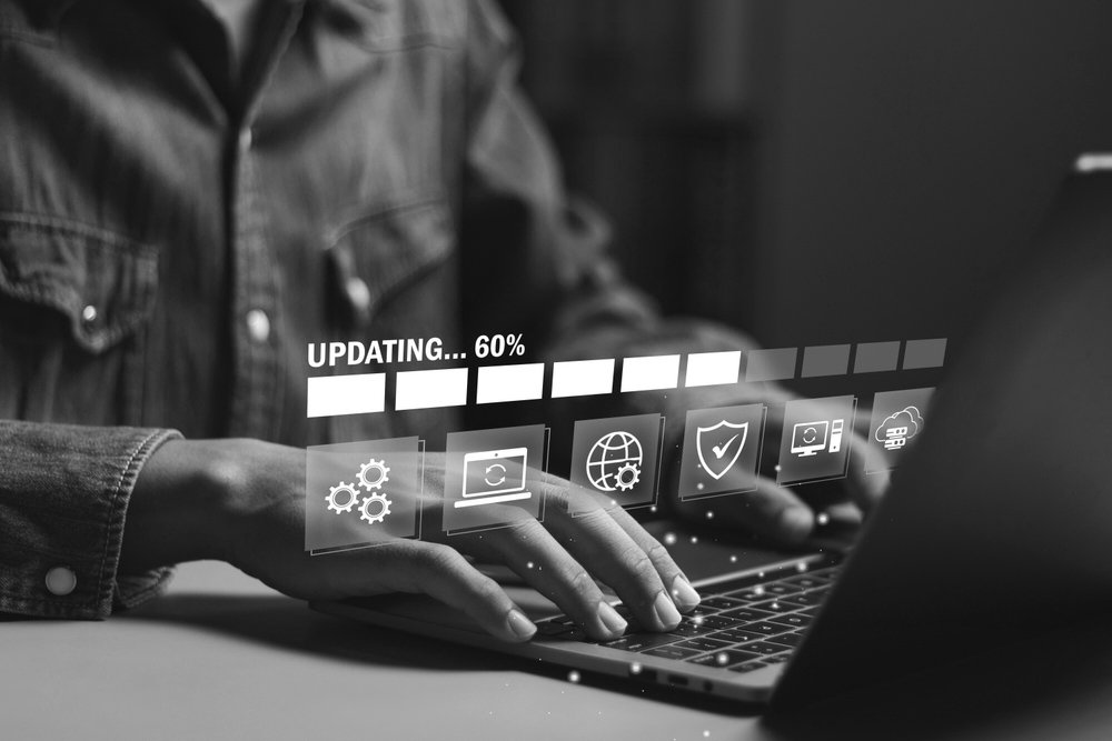 Businessman,Working,And,Installing,Update,Process., ... Businessman working and installing update process. Software updates or operating system upgrades to keep your device up to date with enhanced functionality in new versions and improved security.